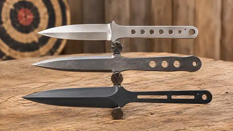 Throwing knives balanced on their center points to show weight distribution