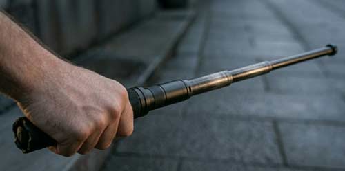 A person carrying an expandable baton