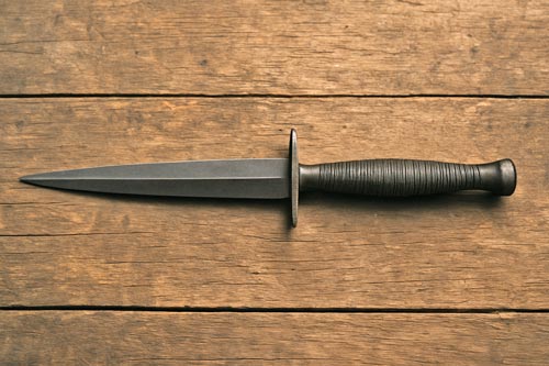 Fairbairn-Sykes fighting knife on a wooden surface