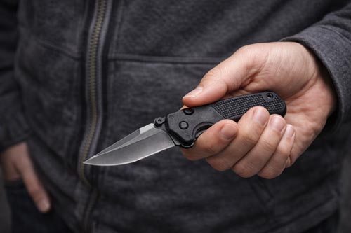 Hand holding a compact folding knife for everyday carry.