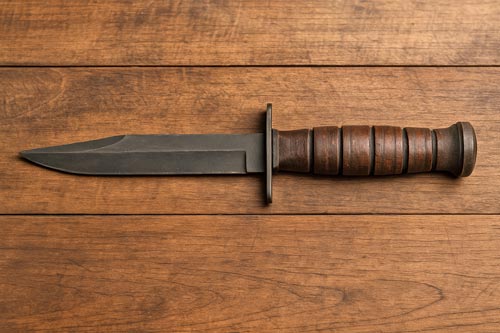 M3 trench knife on a wooden surface.