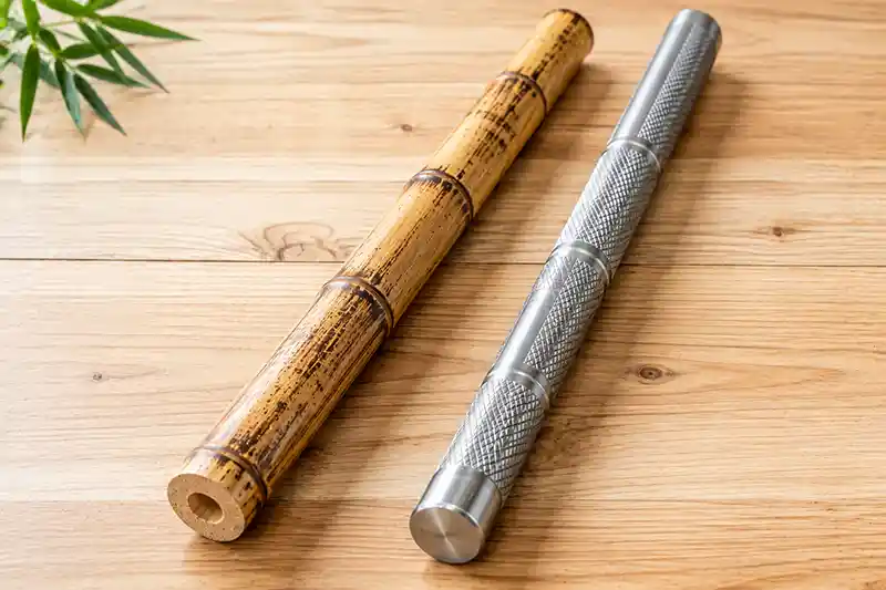 Rattan and titanium escrima sticks side by side