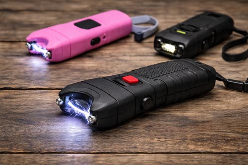 Stun guns with electric arcs displayed