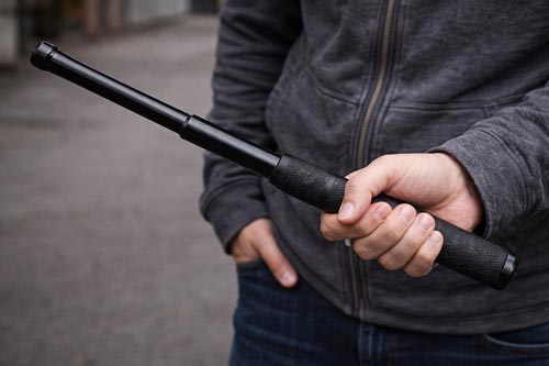 Close-up of telescopic baton in hand